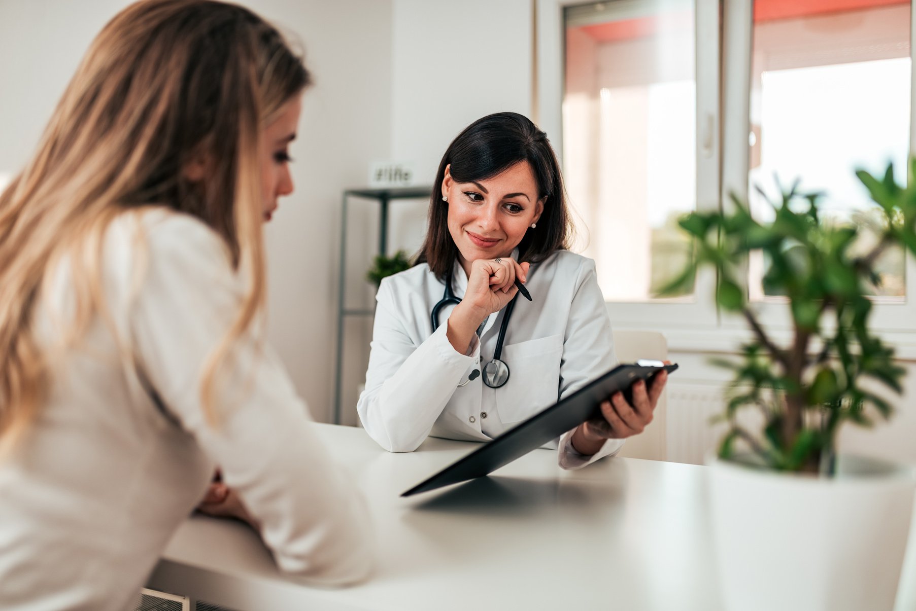 Smiling doctor consulting her patient.