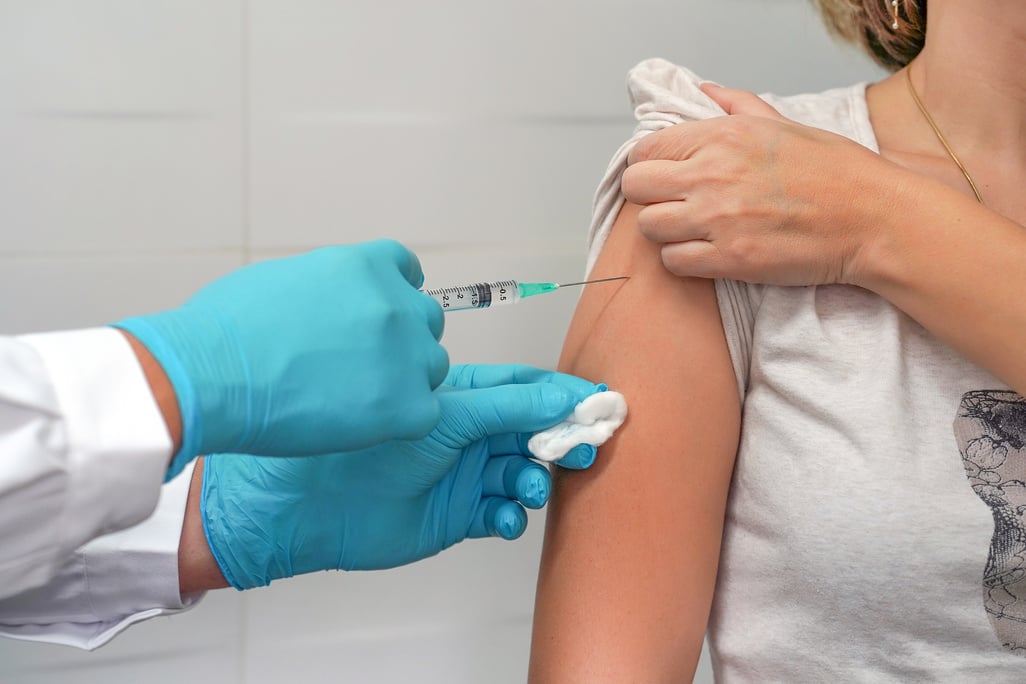 Woman gets vaccinated against flu, flu shot, HPV prevention